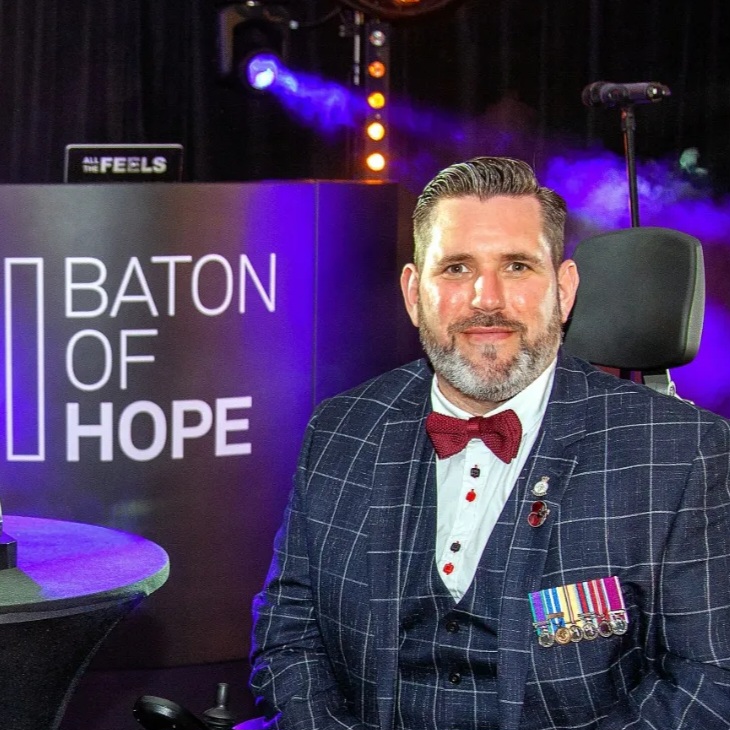 Nick Wilson Disabled Adventurer in a suit at awards ceremony